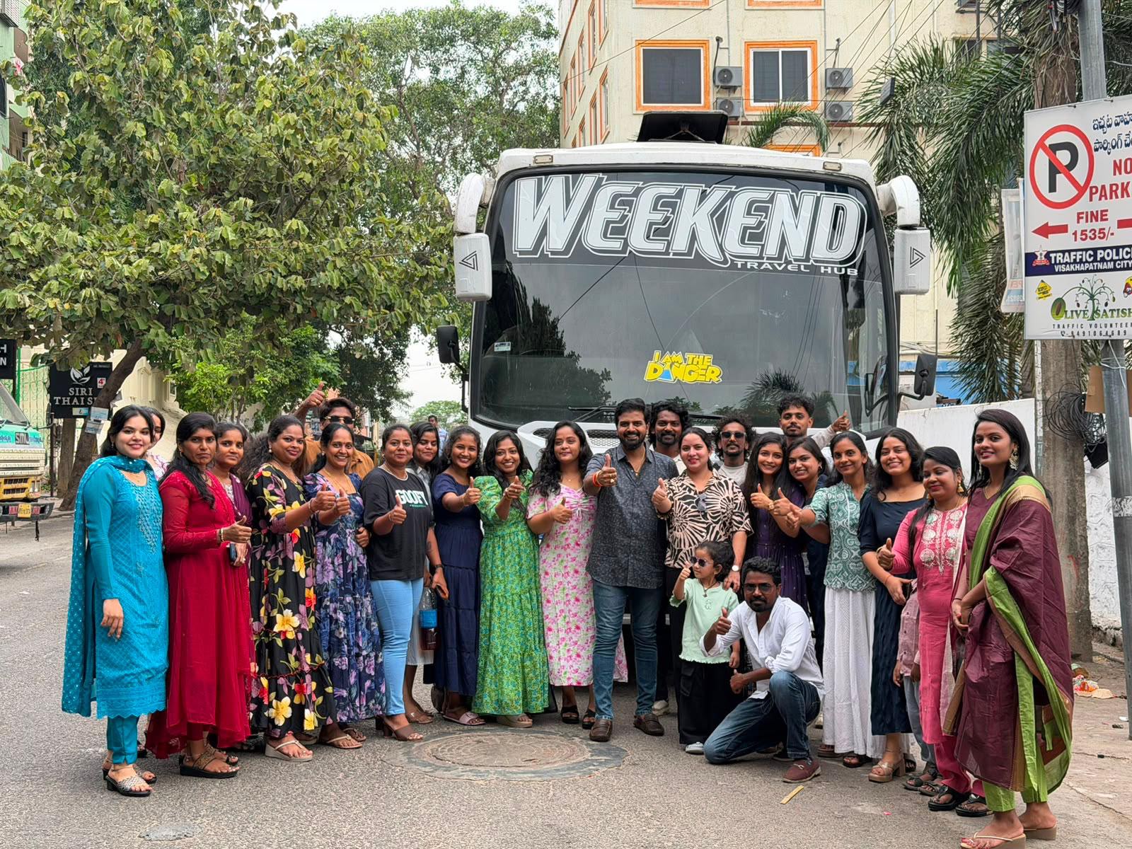 Happy customer group with Weekend Tours and Travels bus